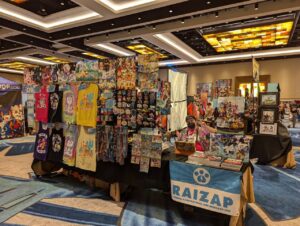 A photograph of RAIZAP by Chu's convention table setup at Megaplex 2024